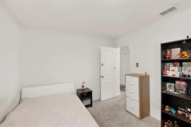 a bedroom with a bed and a book shelf