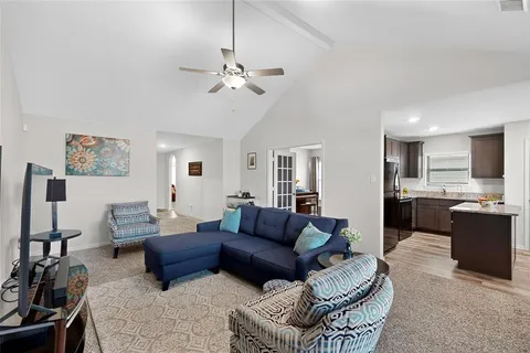 a living room with furniture or kitchen view and a wooden floor