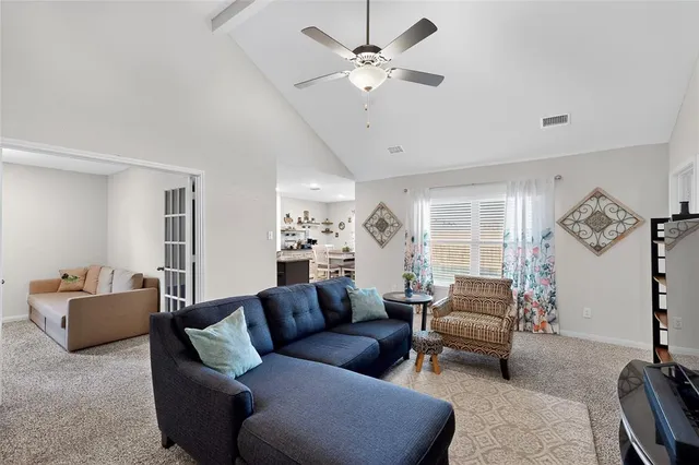 a living room with furniture and a chandelier