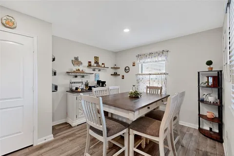 a view of a dining room with furniture and wooden floor