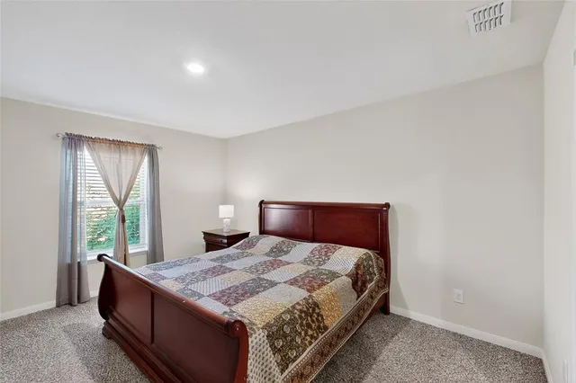 a bedroom with a large bed and a large window