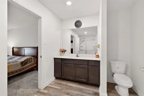 a spacious bathroom with a toilet sink and mirror
