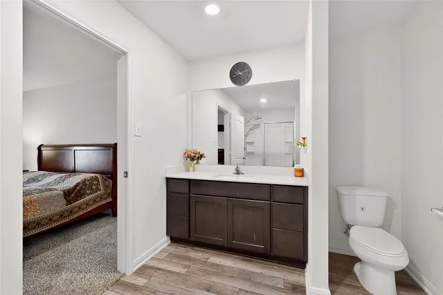 a spacious bathroom with a toilet sink and mirror