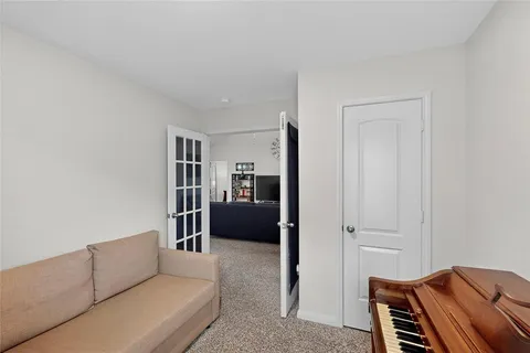 a living room with furniture and a walk in closet