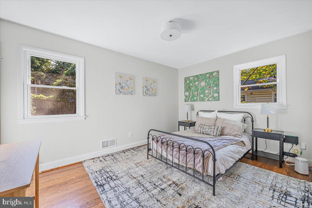 9805 Gardiner Avenue Silver Spring, MD 20902 - Photo 12 of 34 a bedroom with a bed and a lamp on dresser