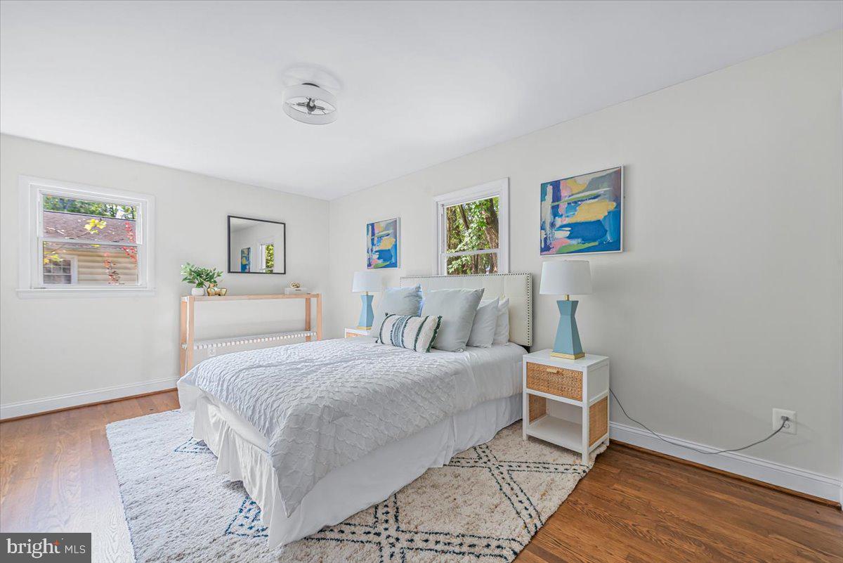 9805 Gardiner Avenue Silver Spring, MD 20902 - Photo 13 of 34 a bedroom with a bed and a painting on the wall