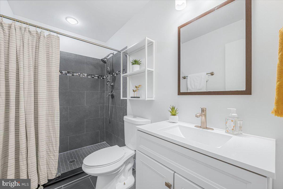 9805 Gardiner Avenue Silver Spring, MD 20902 - Photo 15 of 34 a bathroom with a sink a toilet and shower
