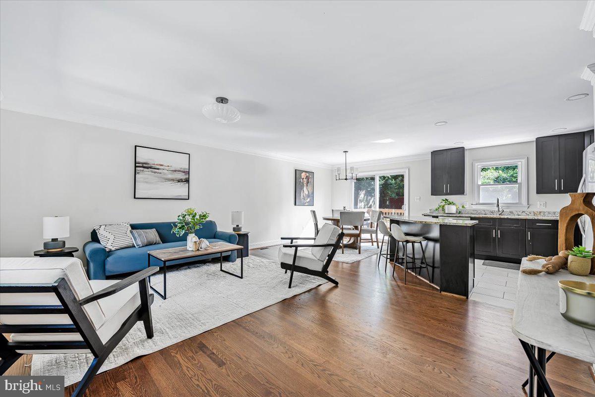 9805 Gardiner Avenue Silver Spring, MD 20902 - Photo 4 of 34 a living room with furniture wooden floor and a flat screen tv