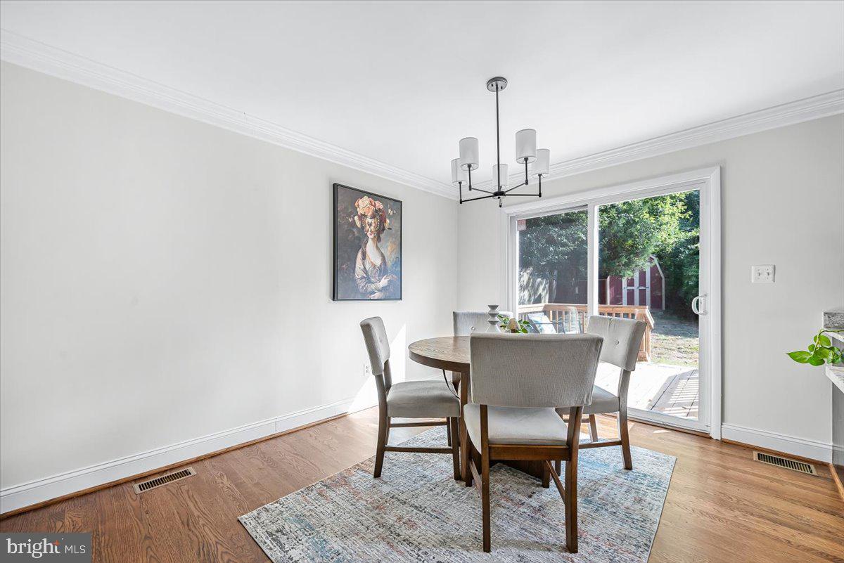 9805 Gardiner Avenue Silver Spring, MD 20902 - Photo 7 of 34 a view of a dining room with furniture window and wooden floor