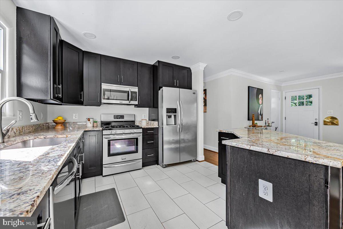 9805 Gardiner Avenue Silver Spring, MD 20902 - Photo 9 of 34 a kitchen with a sink appliances and cabinets