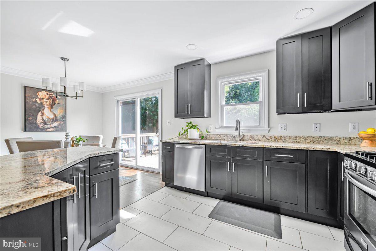 9805 Gardiner Avenue Silver Spring, MD 20902 - Photo 10 of 34 a large kitchen with granite countertop a sink and cabinets