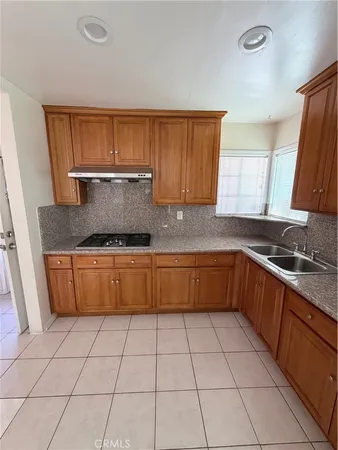 a kitchen with a sink a stove and a cabinets