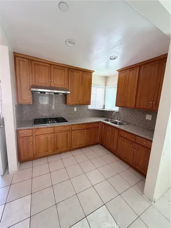 a kitchen with granite countertop a sink and a stove