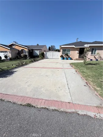 a front view of a house with cars parked