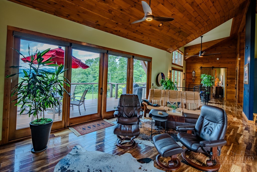 179 Adams Road Vilas, NC 28692 - Photo 11 of 50 a living room with furniture floor to ceiling window and potted plants