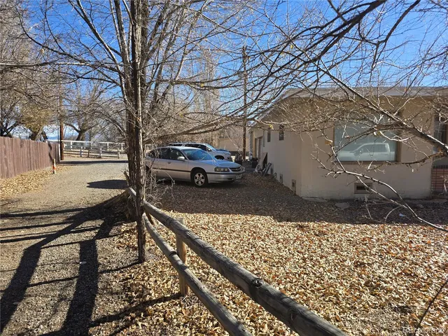 a view of a backyard with wooden fence