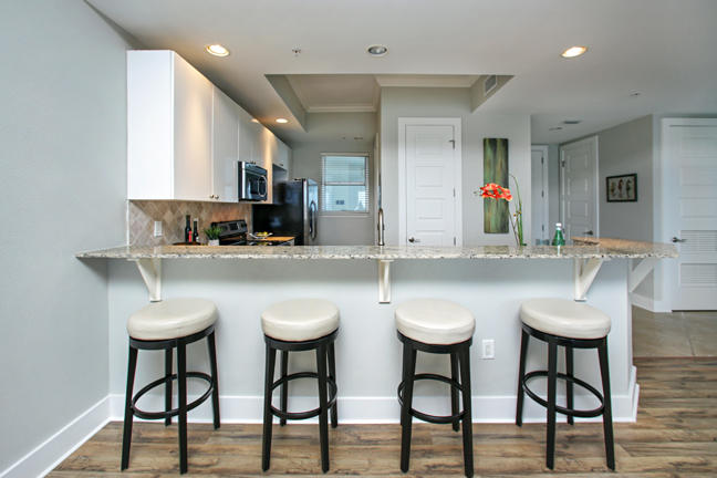 211 Durango Road, Unit 516 Destin, FL 32541 - Photo 7 of 27 a kitchen with white cabinets and chairs