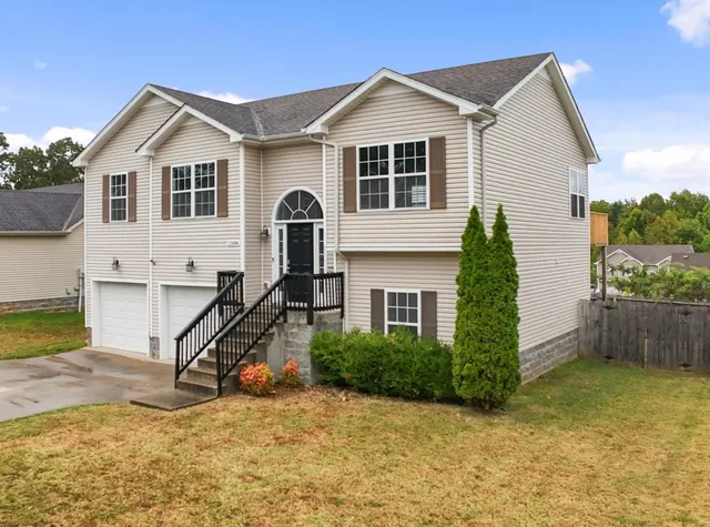 a view of a house with a wooden fence