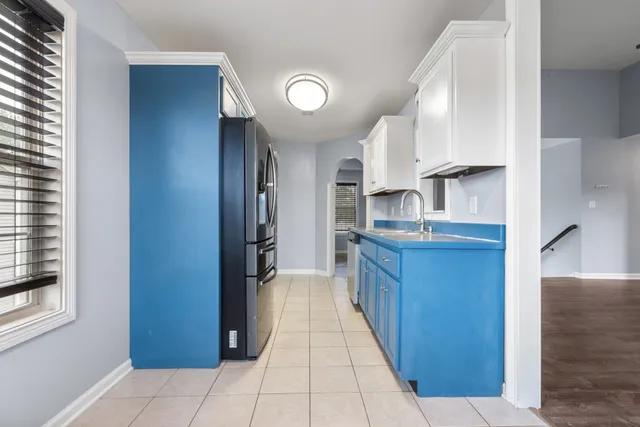 a kitchen with stainless steel appliances granite countertop a refrigerator and a sink