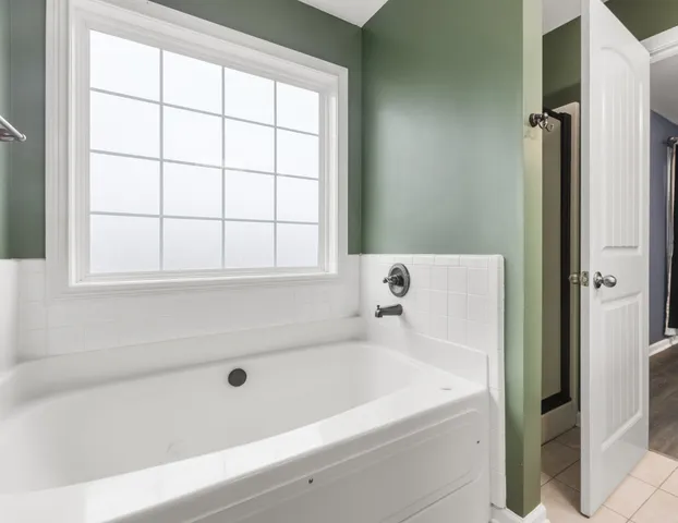 a white bath tub sitting next to a window