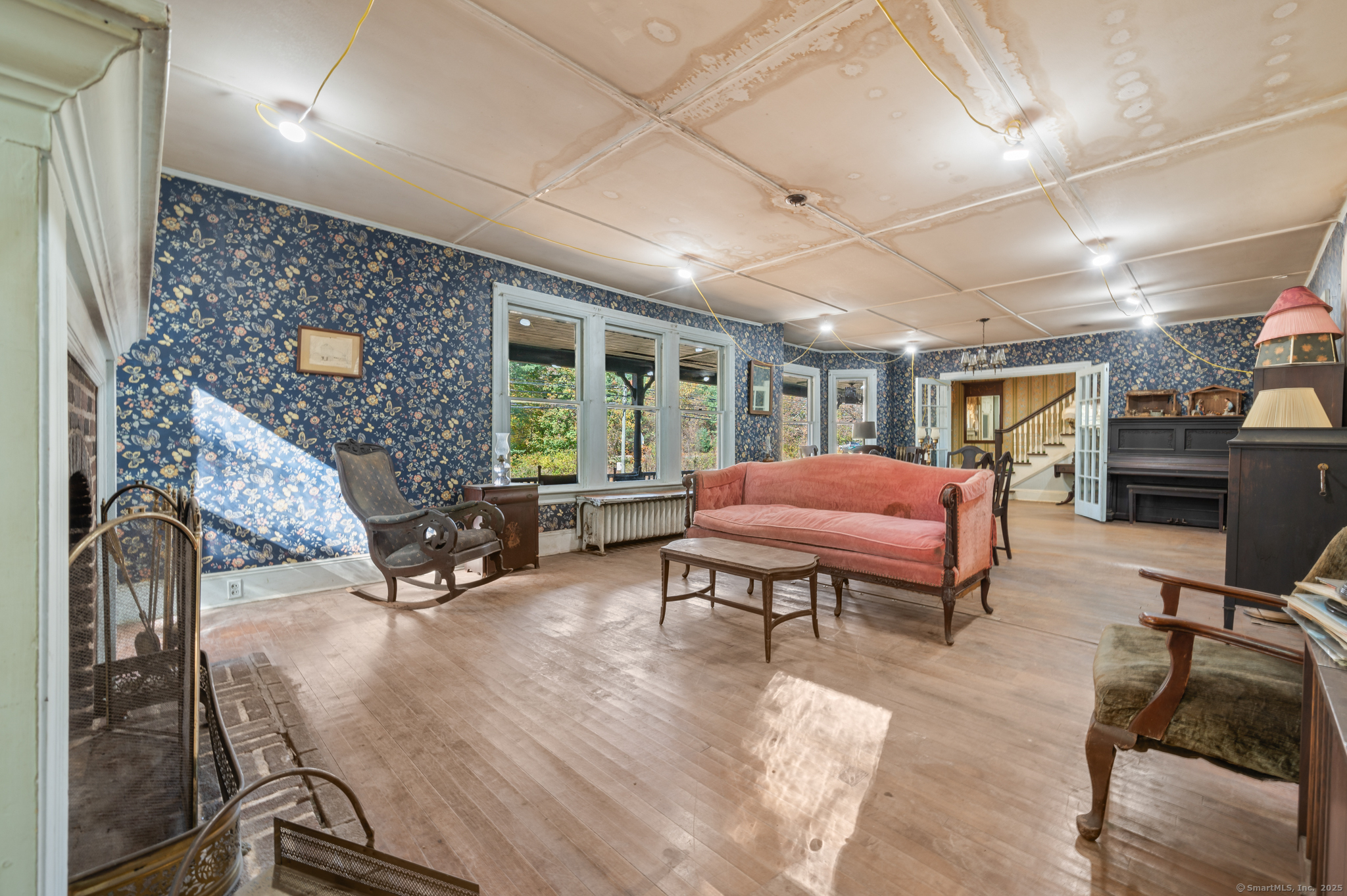 124 River Road Willington, CT 06279 - Photo 10 of 38 a living room with furniture a piano and a bookshelf