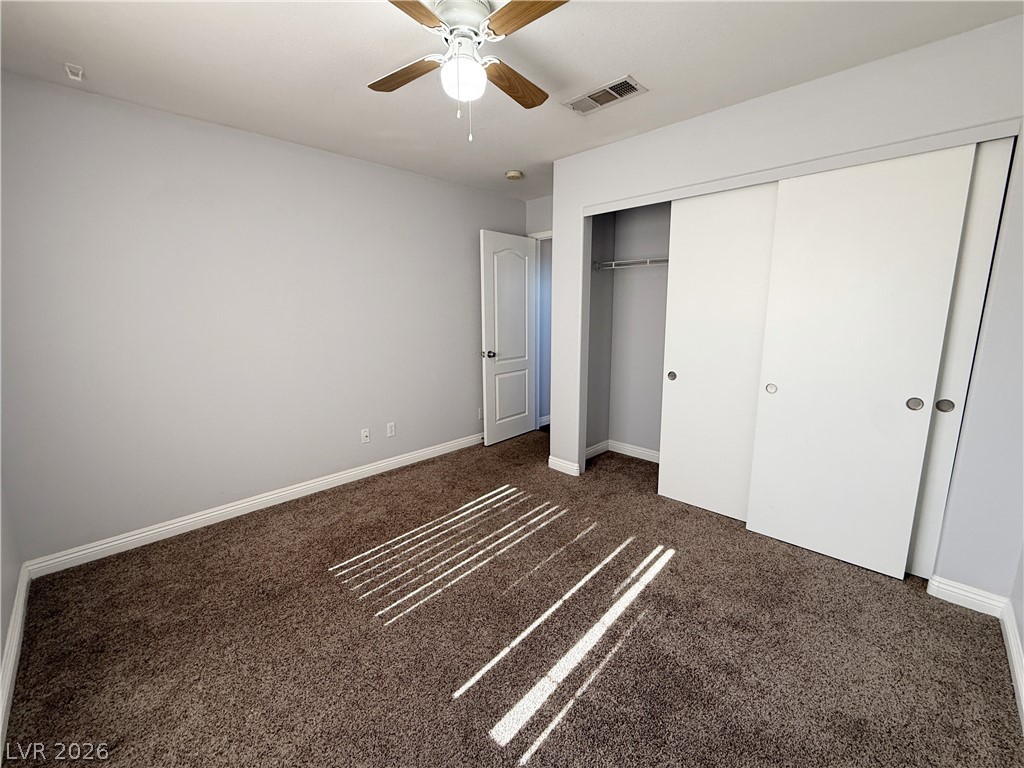 2185 Polynesia Circle Henderson, NV 89074 - Photo 22 of 37 A well-proportioned room with warm carpet and a functional ceiling fan.