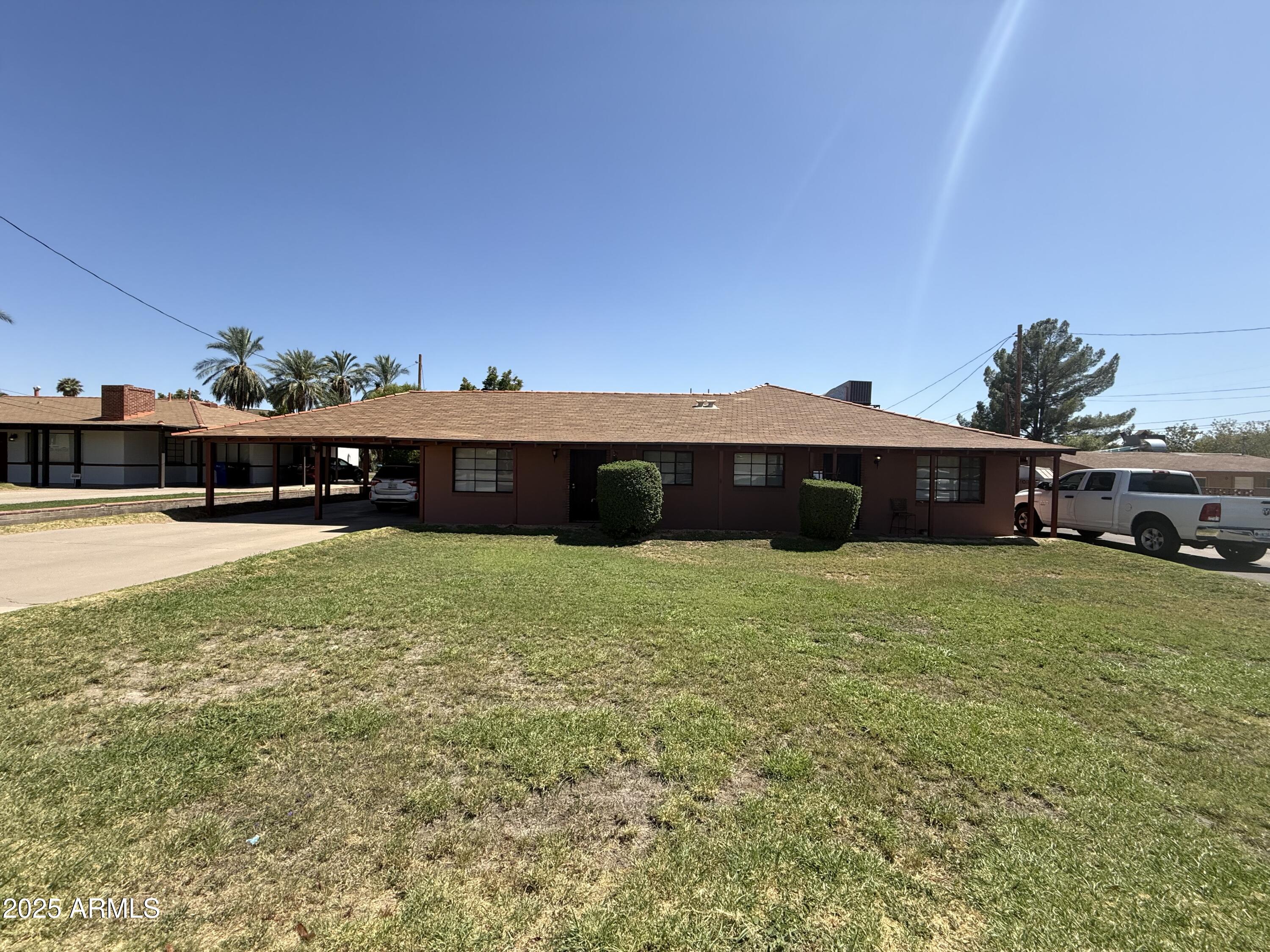 5107 East Oak Street, Unit 3 Phoenix, AZ 85008 - Photo 1 of 6 a view of a house with a yard