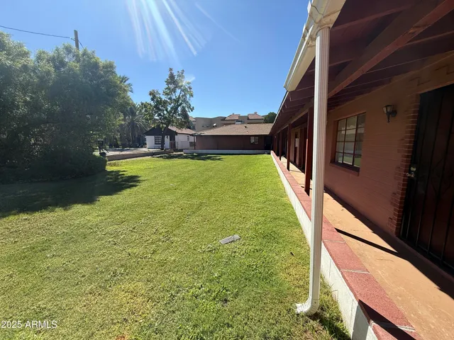 a view of a swimming pool with a yard
