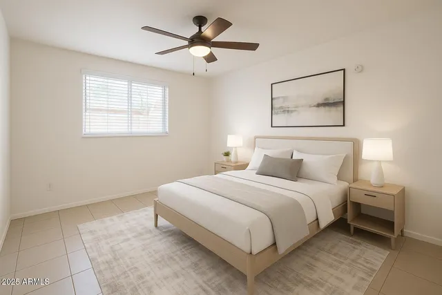 a bedroom with a bed and a painting on the wall