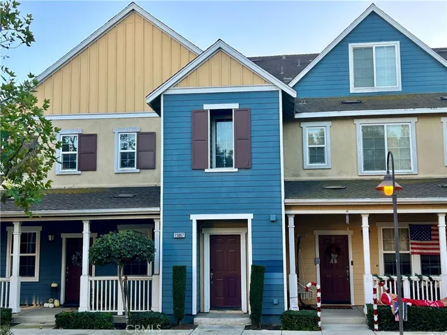 a view of a brick house with large windows