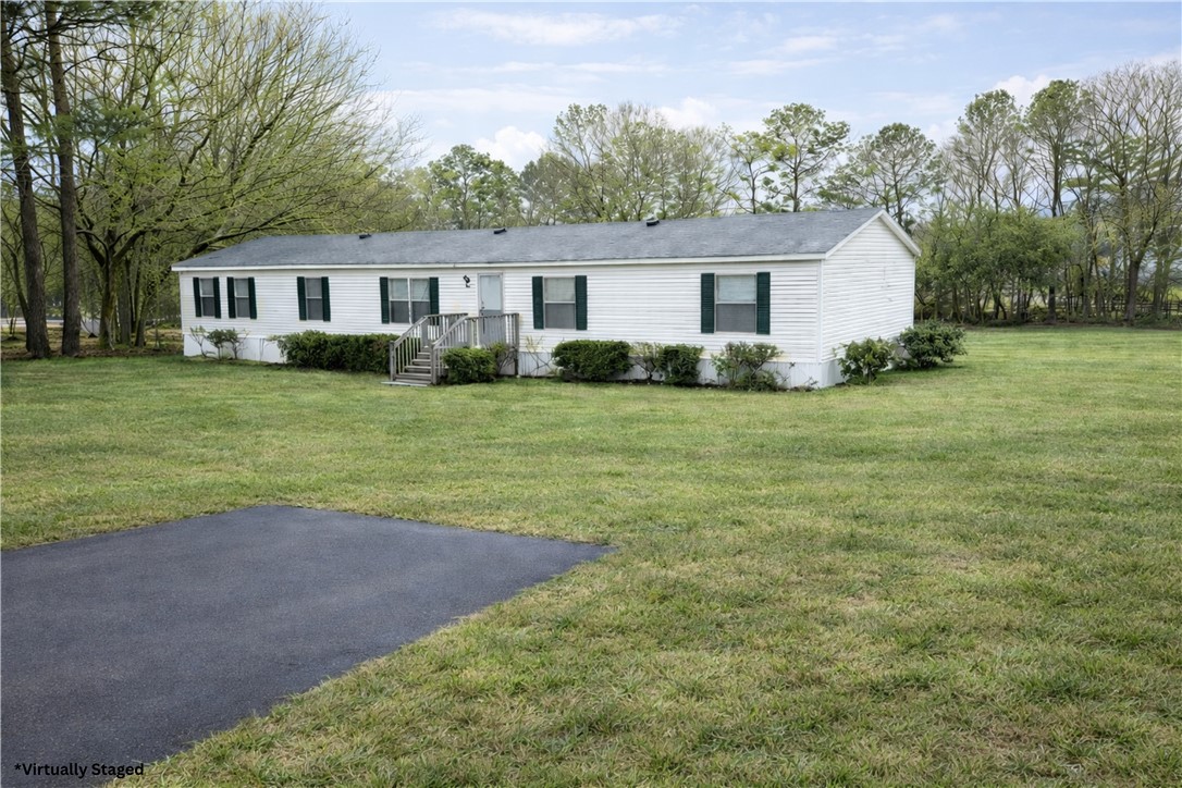 This charming home sits on an expansive lot, offering ample space and serene surroundings.