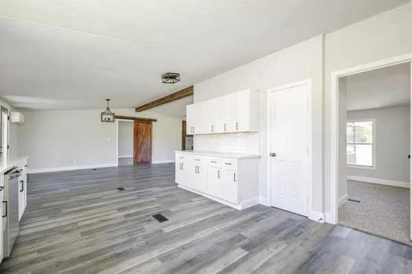 a view of kitchen with wooden floor and electronic appliances