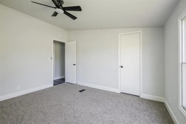 a view of a room with a ceiling fan