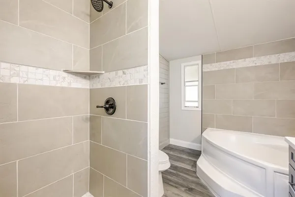 a bathroom with a bathtub and a shower