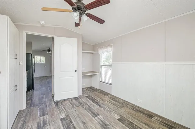 a view of empty room with wooden floor