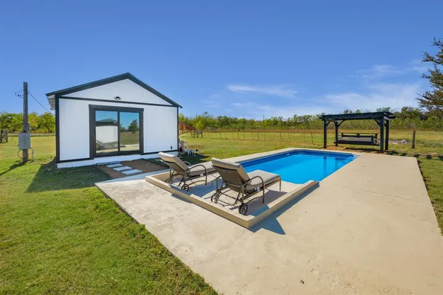 a view of a house with swimming pool and porch