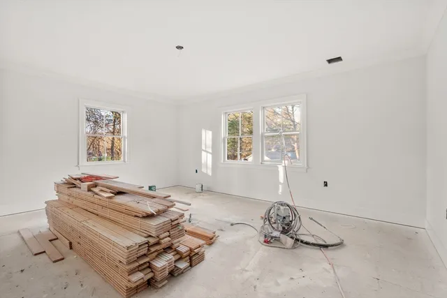 a room with a baby bed baby crib and a window