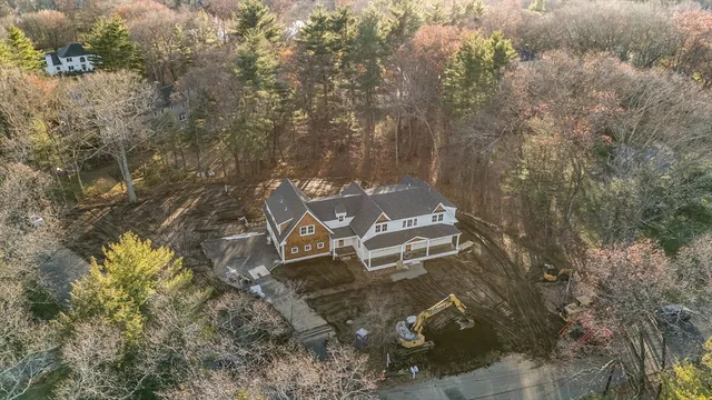 an aerial view of a house with yard and outdoor seating