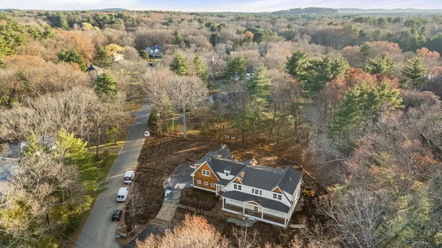 an aerial view of a house with a yard