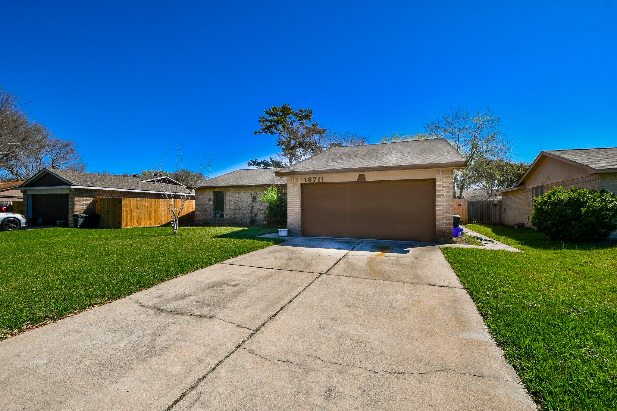 16711 Ribbonridge Drive Sugar Land, TX 77498 - Photo 1 of 24 a front view of a house with a yard and garage