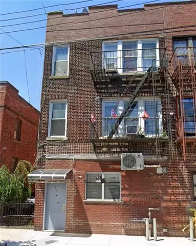a view of a brick building with many windows