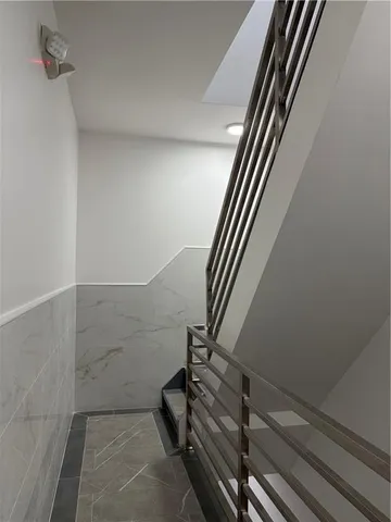 a view of staircase with white walls