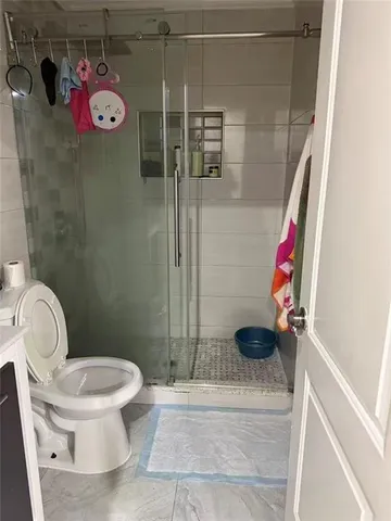 a bathroom with a toilet and a shower