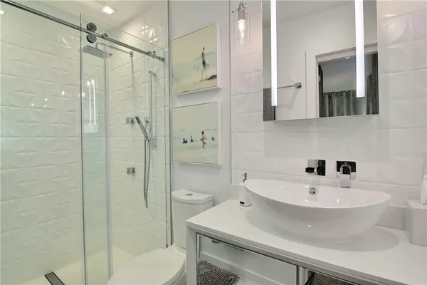 a bathroom with a sink toilet and shower
