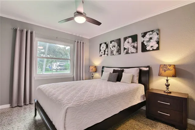 a bedroom with a large bed and a window