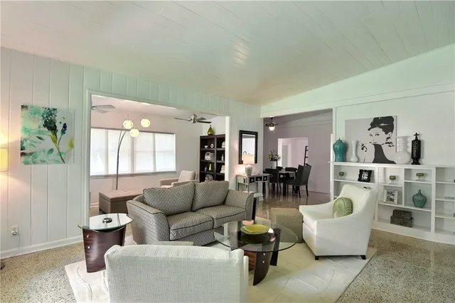 a living room with furniture and white walls