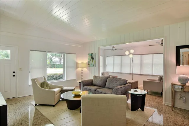 a living room with furniture and a potted plant