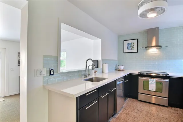 a kitchen with a sink and a stove top oven