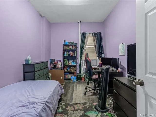 a bedroom with a bed a desk and chair