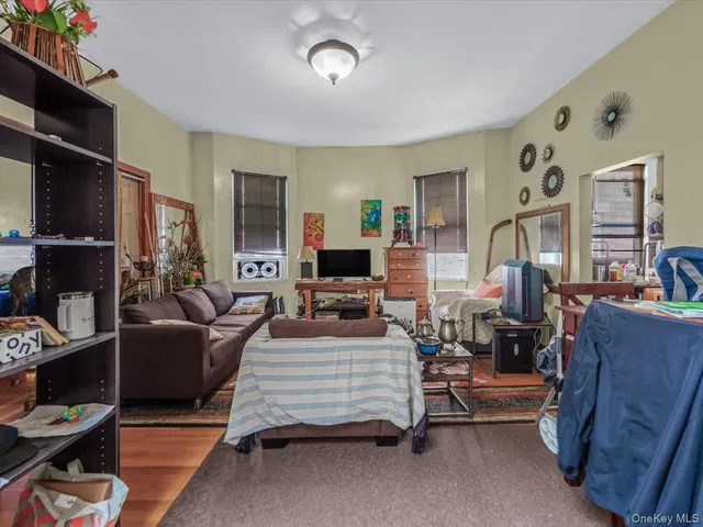 a bedroom with furniture and a flat screen tv